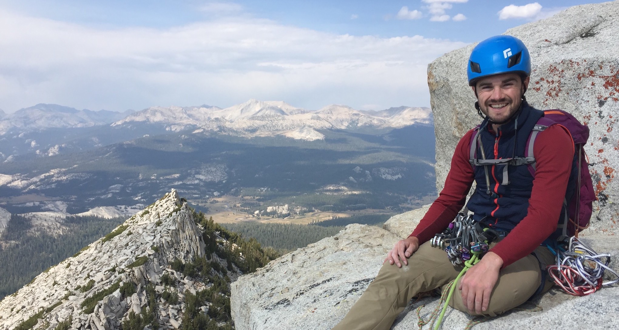 Paul on a mountain peak over looking an alpine meadow