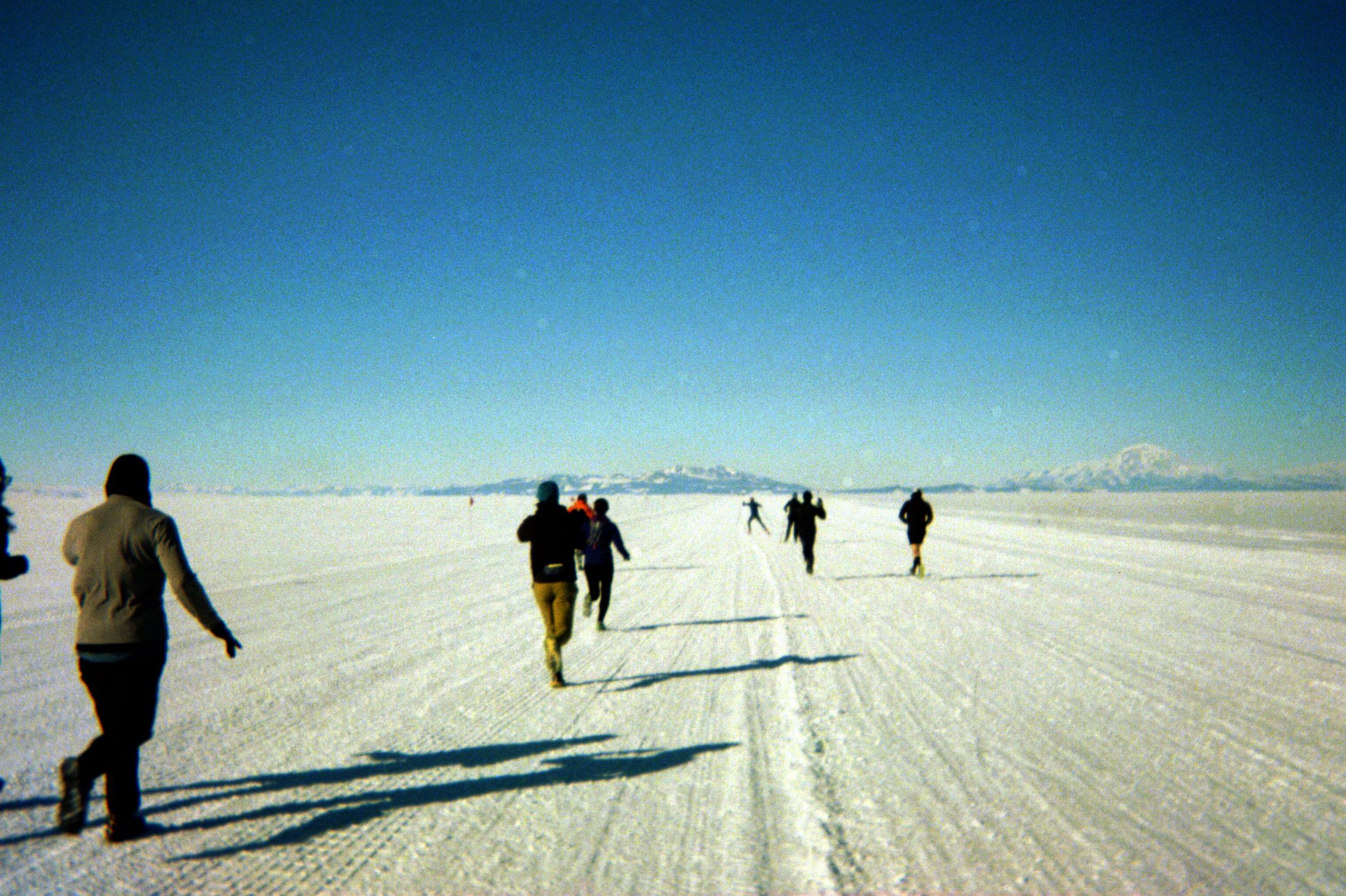 Runners on a snow covered ice shelf in Antarctica