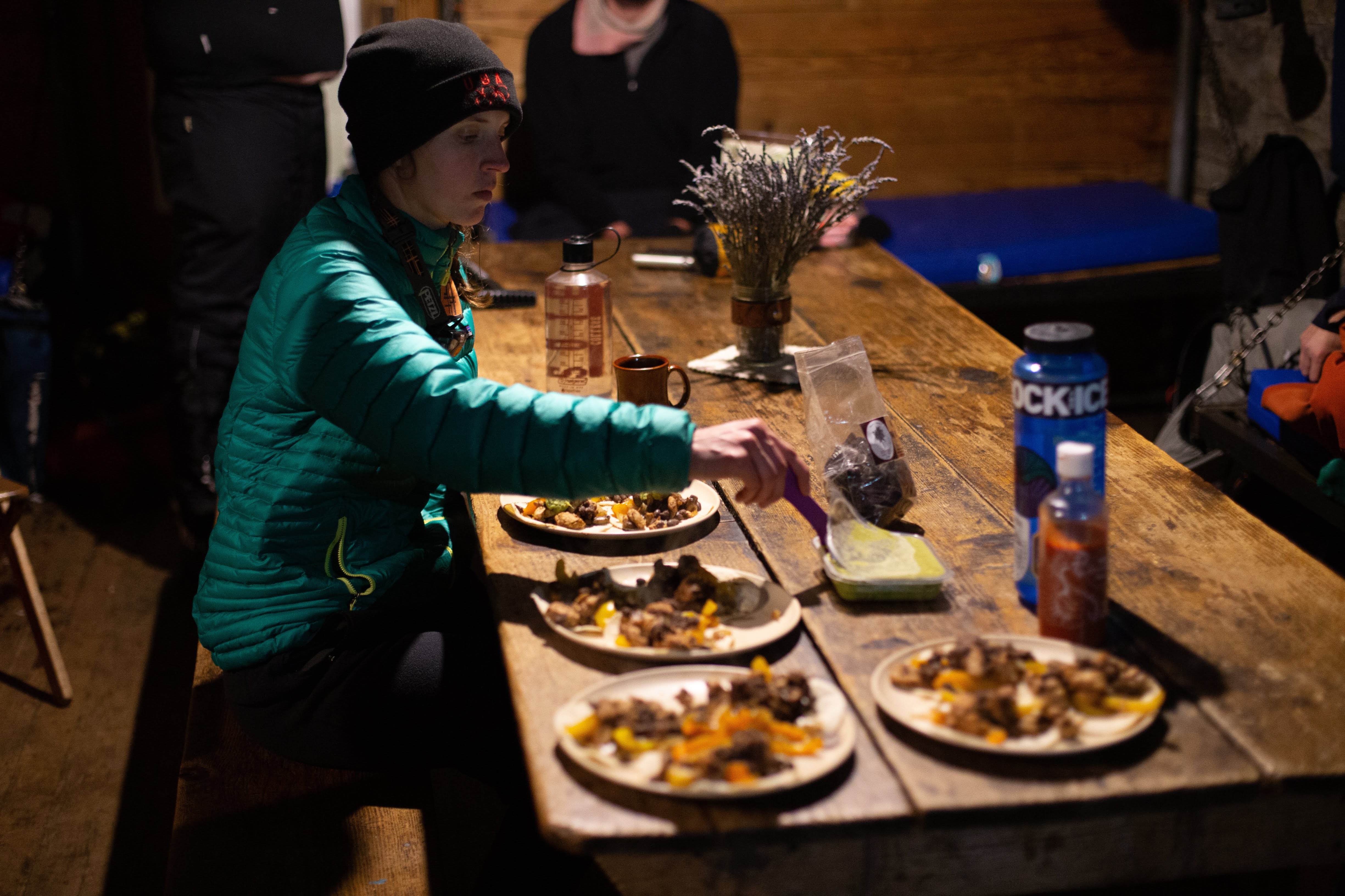 People eating dinner in Pear Lake Hut