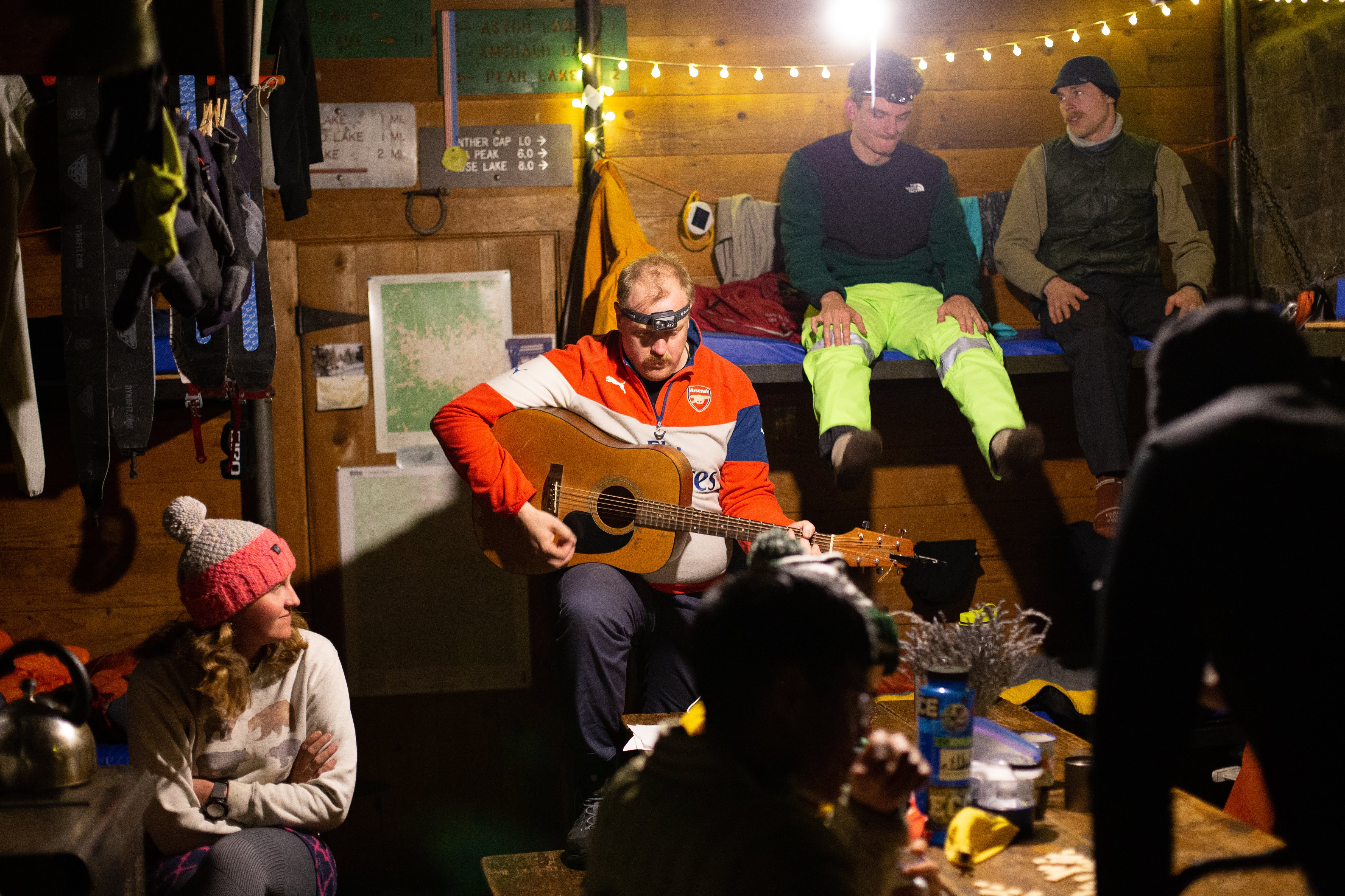 People listen to a guitar in the hut