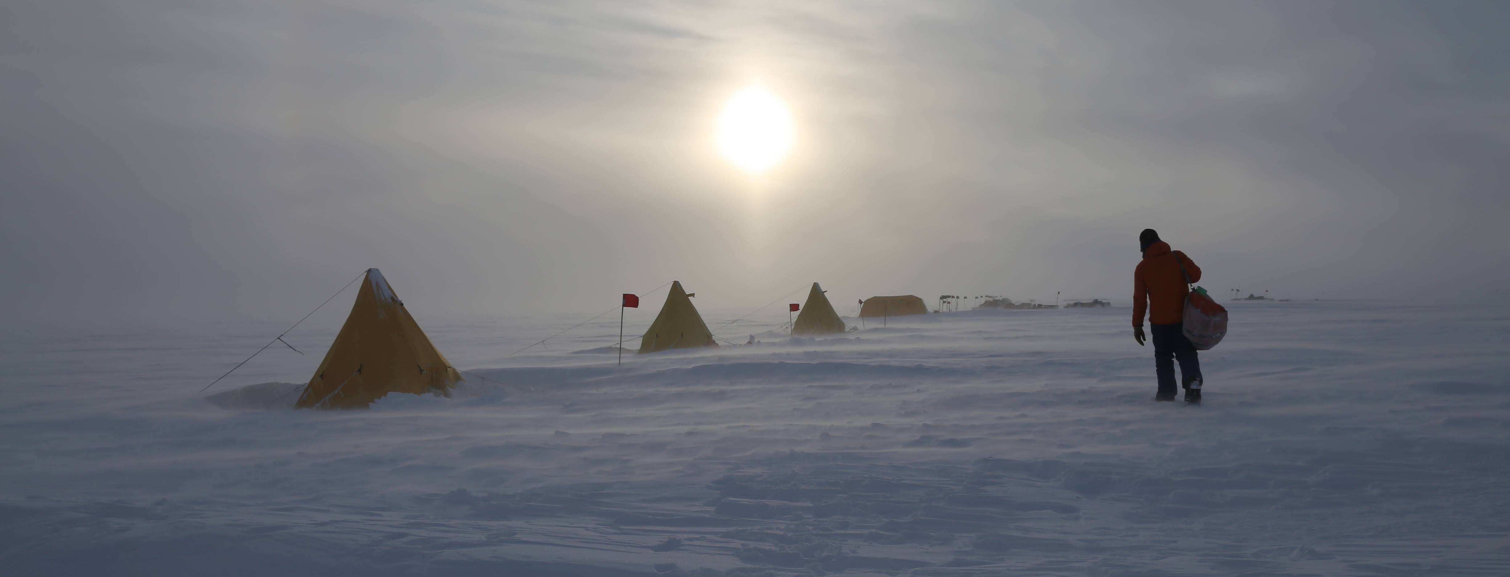 Person walking through a mild storm at an antarctic field camp